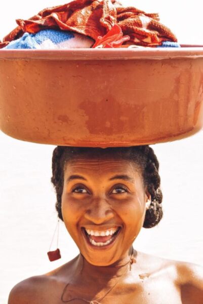 Woman carries washing on her head in Madagascar 