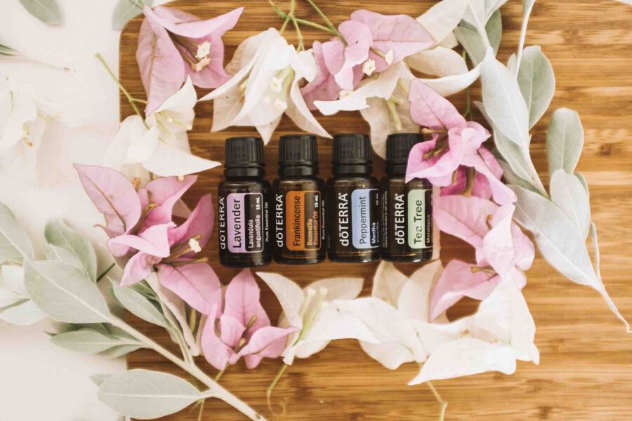 doterra essential oils on a bed of flowers flatlay