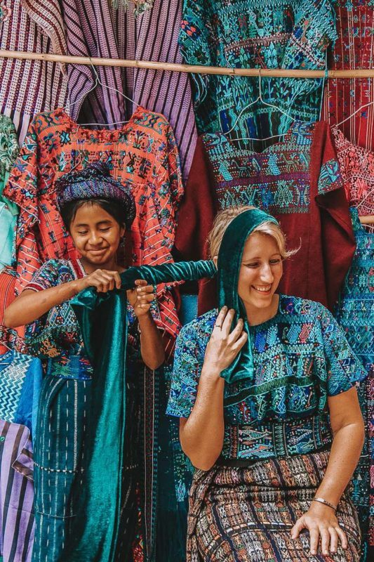 Trying on a traditional dress in Guatemala