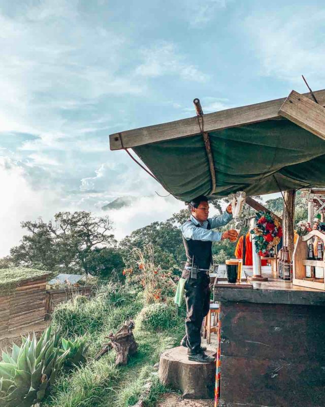 guatemalan male pouring beers on tap in the mountains