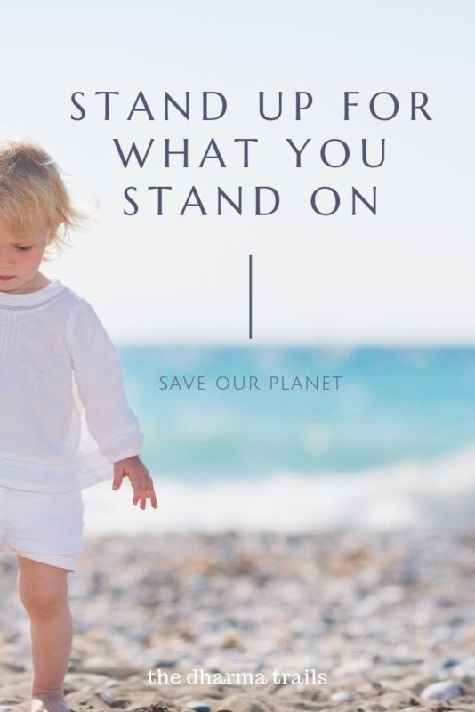 Baby at beach with text overlay stand up for what you stand on