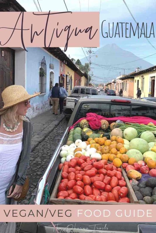 girl looking at fresh fruit in Antigua Guatemala with text overlay vegan food guide to Antigua Guatemala 