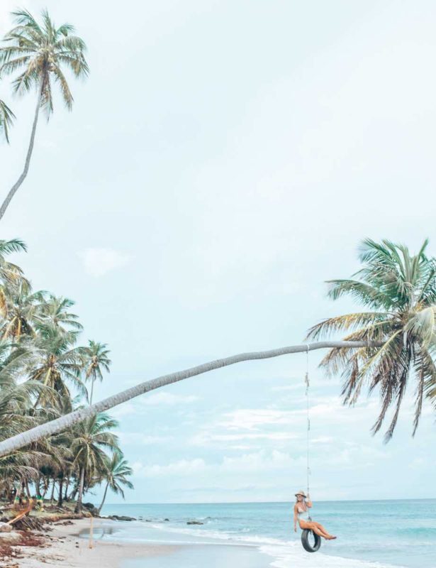 Swinging on a palm tree at Sauteurs Beach Grenada