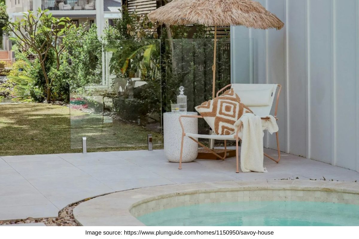 aesthetic pool with chair and thatched umbrella at a broadbeach holiday rental