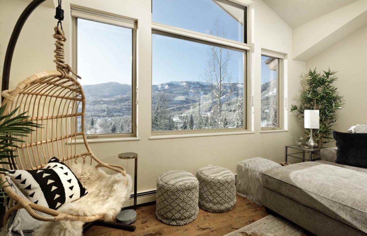 hanging chair next to a window with views of the snowmass mountains