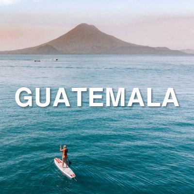 paddleboarding on lake atitlan with volcano and sunset